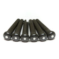 Six black bridge pins each with a white dot on top laid side by side.