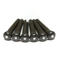 Six black bridge pins with white circular inlays on their tops lined up on a white background.