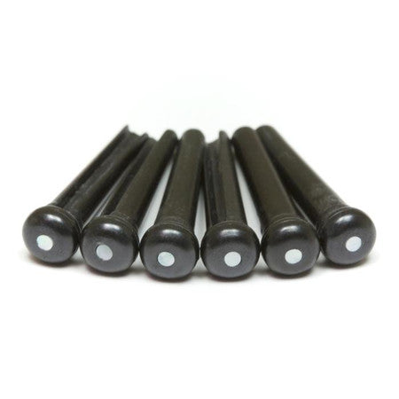 Six black bridge pins with white circular dots arranged in a row on white background.