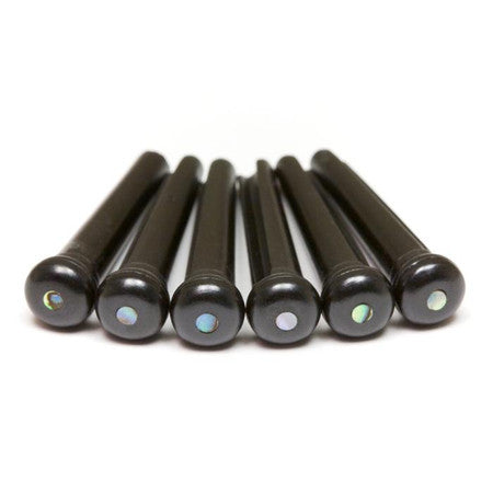 Six black cylindrical bridge pins with abalone decorative dots on tops arranged in a row on white background.