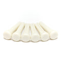 Six white plastic bridge pins arranged in a row on a white background.