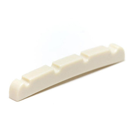 Off-white plastic or synthetic string nut with four grooves for strings.