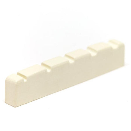 Close-up view of a cream-colored slotted nut for a stringed instrument with five string slots.