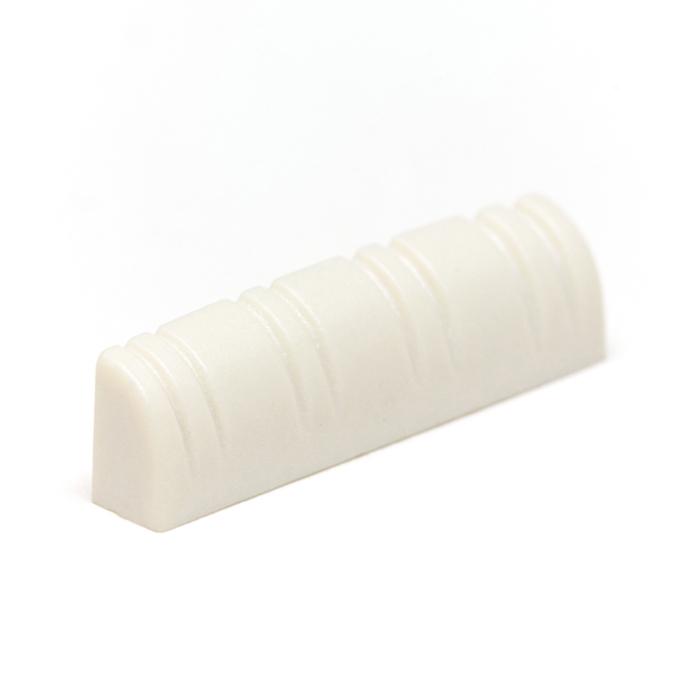 White slotted nut piece with six string-width grooves on a white background.
