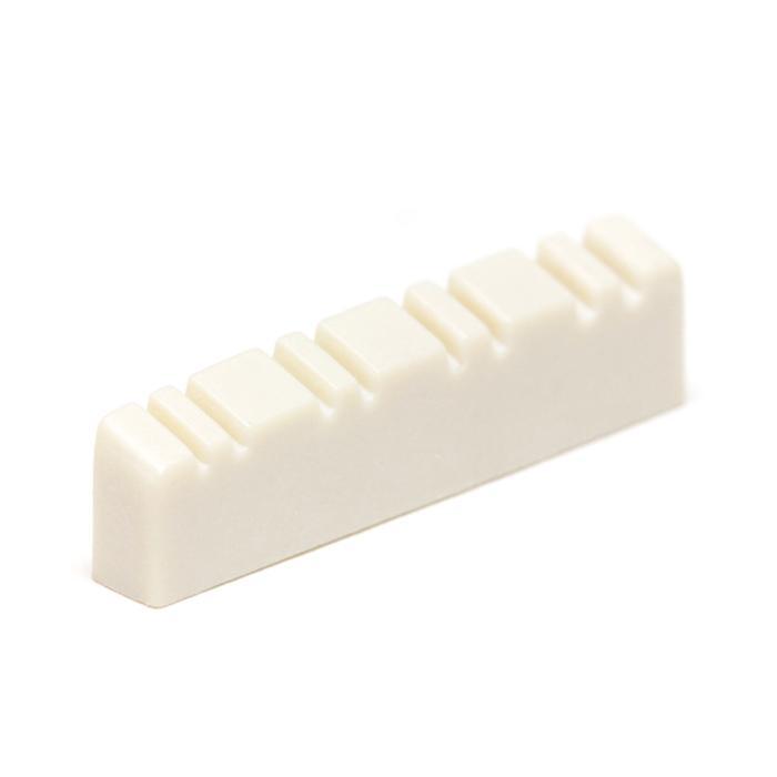 White slotted nut with multiple string slots, likely for a stringed instrument.
