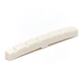 Off-white plastic slotted guitar nut with six slots and a slight upward curve.