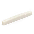 White flat slotted guitar nut with six evenly spaced slots viewed at an angle.