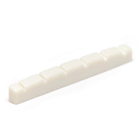 White flat slotted guitar nut with six evenly spaced slots viewed at an angle.