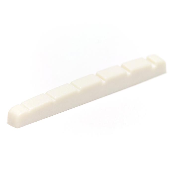 White slotted guitar nut with six string slots and a flat bottom