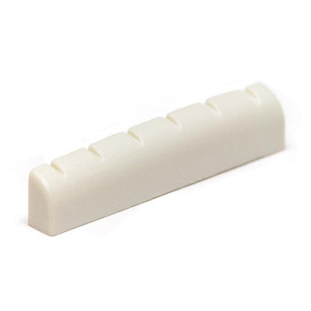 White slotted guitar nut with six slots on a white background.