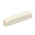 Off-white slotted guitar nut with six evenly spaced slots.