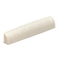 White slotted guitar nut with six evenly spaced slots for strings.