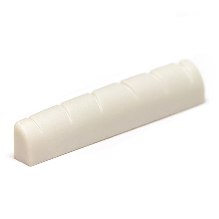 White slotted guitar nut with six evenly spaced slots for strings.