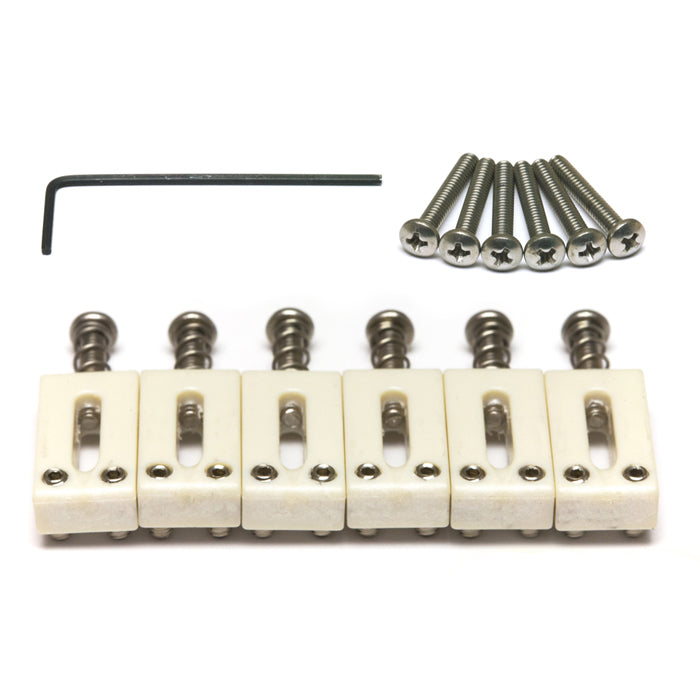 Six white guitar saddles with metal screws and an L-shaped hex key arranged on a white background.