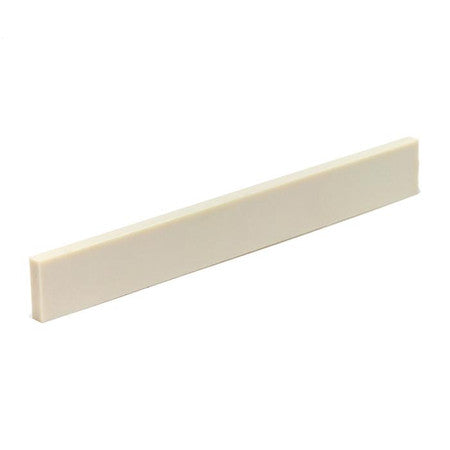 Off-white rectangular plastic slab, possibly a guitar saddle or similar guitar part.