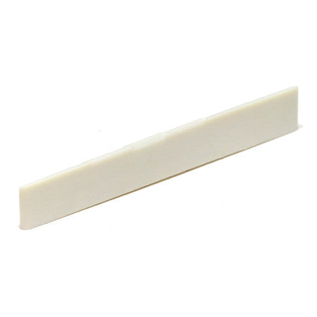 White rectangular piece likely used as a saddle for a stringed instrument.