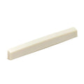 Off-white rectangular tapered piece likely a plastic saddle or nut for a stringed instrument.