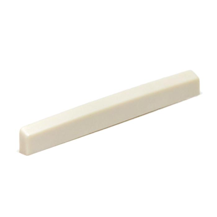 Off-white rectangular tapered piece likely a plastic saddle or nut for a stringed instrument.