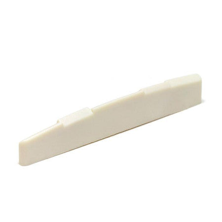Off-white guitar saddle with multiple compensation notches, photographed on a white background.