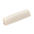 Off-white plastic guitar nut shown from an angled side view with a smooth curved top.