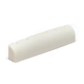A white slotted guitar nut with six slots in a curved, rectangular shape.