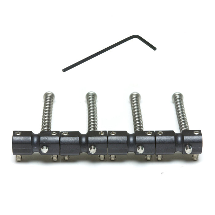Four black metal guitar saddles with adjustment screws and an L-shaped allen wrench on a white background.