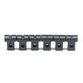Six black metal string guides with threaded holes aligned in a row on a white background.