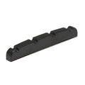 Black four-string nut with slots for string placement, likely for a guitar or bass instrument.