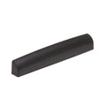 Black plastic guitar nut or saddle with a curved top and flat base.