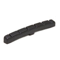Black plastic curved slotted guitar nut with six slots for strings.