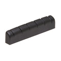 Black rectangular slotted guitar nut with six string slots, shown from an angled side view.