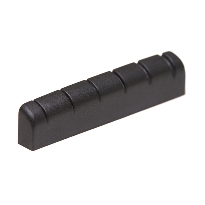 Black rectangular slotted guitar nut with six string slots, shown from an angled side view.