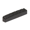 Black guitar nut with six evenly spaced string slots viewed at an angle.
