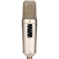 Silver cylindrical studio microphone with mesh grille and control panel with switches on its body