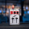 Metal audio pedal with three colored push buttons and two sliders, labeled S. Hawk Ltd.