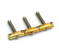 Set of three brass saddles each with a spring and screws, arranged in a row on a white background.