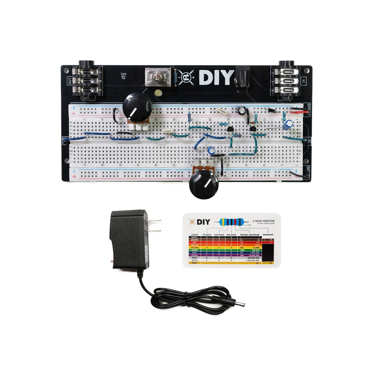 Breadboard mounted circuit with knobs, power adapter, and resistor color code card on a white background