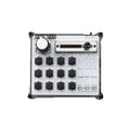 White noise machine device with one rotary knob, one slider, and a 4x4 grid of push buttons.