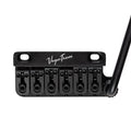 Black metal guitar tremolo bridge with six string saddles and a tremolo arm on right side