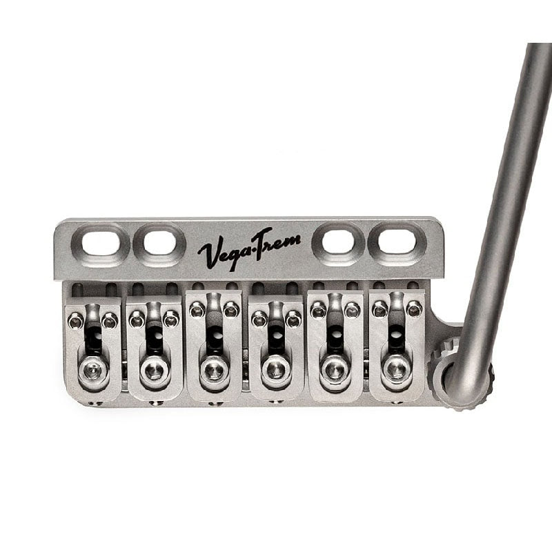 Silver metal guitar bridge with six saddles and attached tremolo arm labeled VegaTrem.
