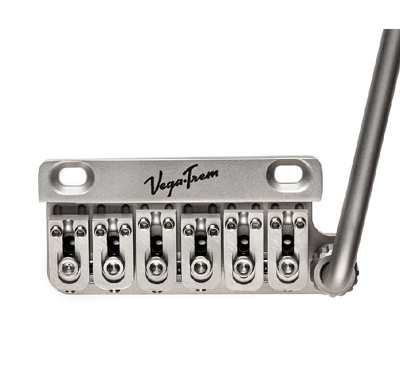 Silver metal bridge with six adjustable saddles and arm labeled VegaTrem.