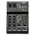 Top view of a black audio mixing console with knobs, buttons, combo inputs, and labeled outputs.