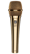 Gold-colored wired microphone with mesh grille and branding on the handle.