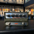 Front view of a green textured Warm Audio pedal with knobs and footswitches labeled chorus and vibrato controls.