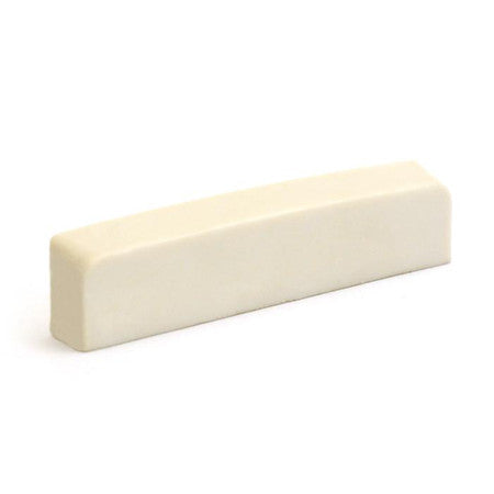 Off-white rectangular guitar nut with a smooth surface and no visible markings, shown on a white background.