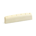 Off-white slotted nut for stringed instrument shown on white background.