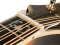 Close-up of a mandolin headstock showing a white slotted nut with strings and tuning pegs.